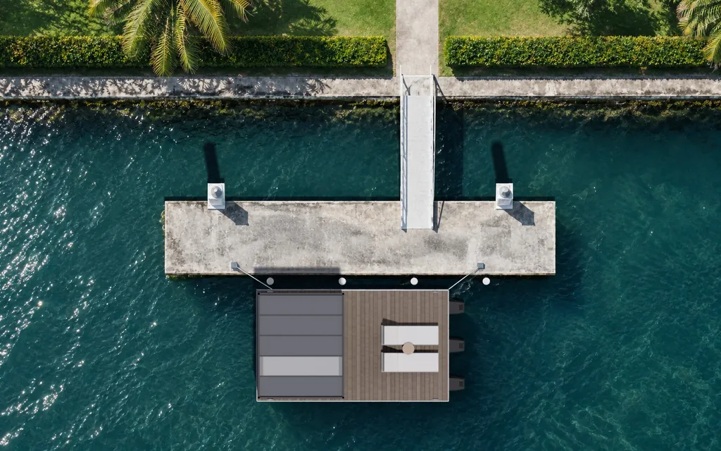 Straight-down aerial view of the Driftroom Studio moored beside a canal pontoon